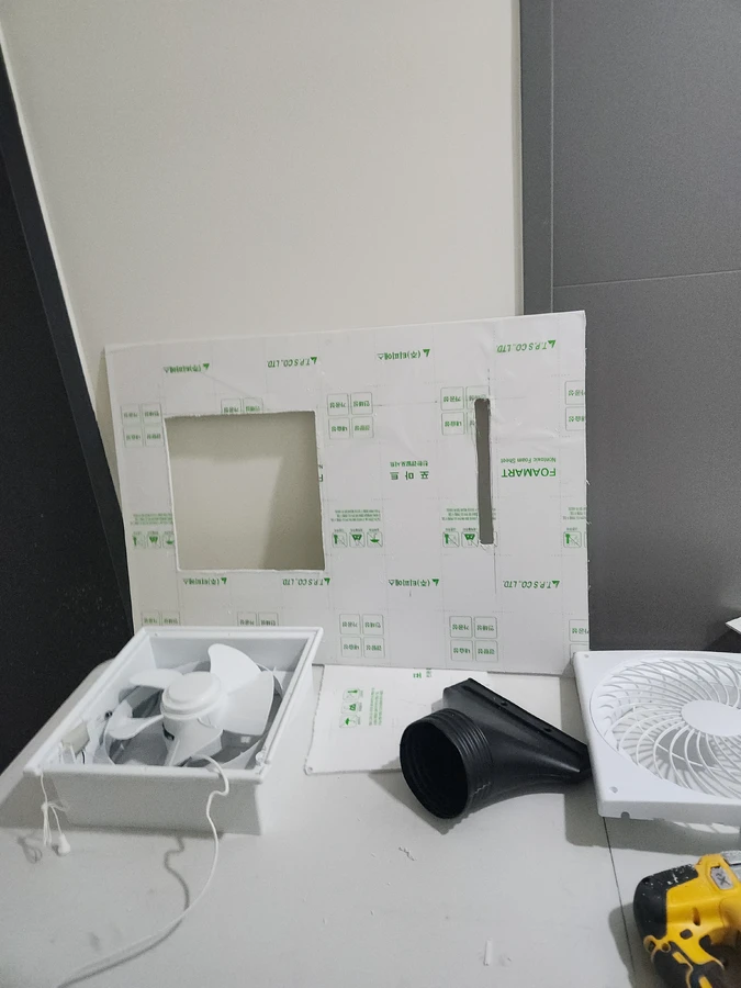 창틀 개구부에 환풍기 본체를 고정하는 모습